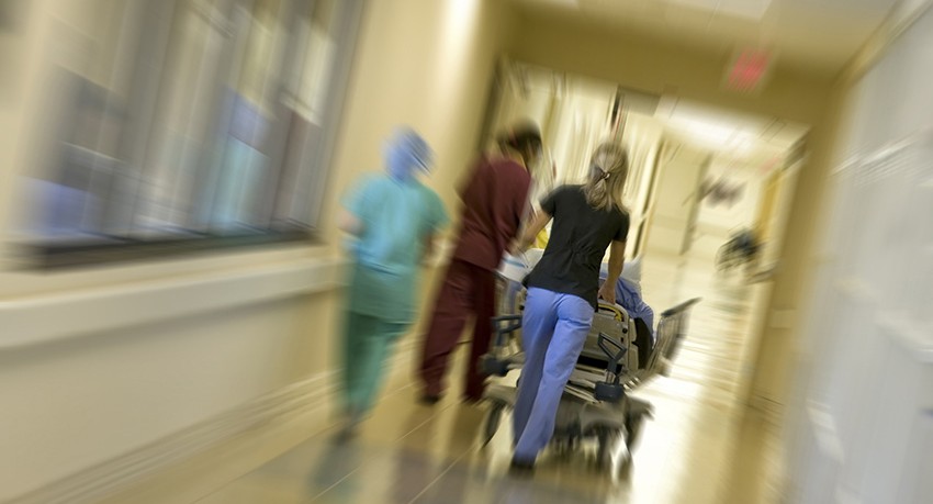 Nurses rushing through hall with patient