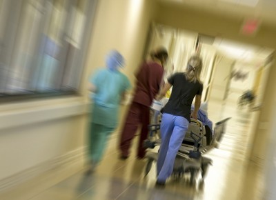 Nurses rushing a patient to the emergency room for surgery.