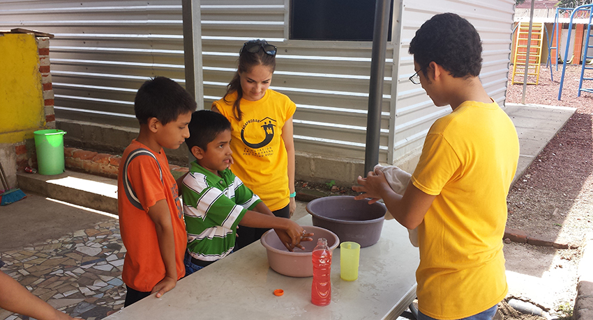 Worcester State University students teach El Salvadoran children about importance of washing their hands.