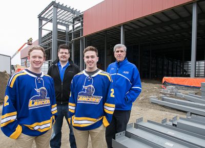 A few members of the Worcester State University men's hockey team and coaches in front of new ice rink