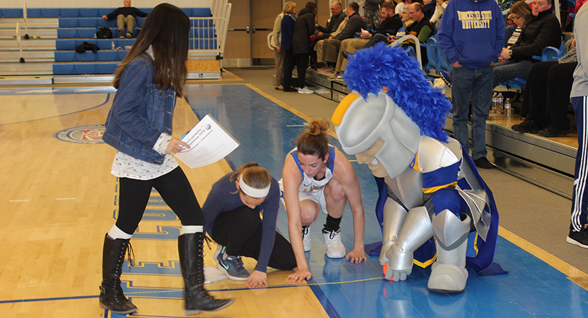 Worcester State mascot helps Worcester schoolchildren measure basketball court.